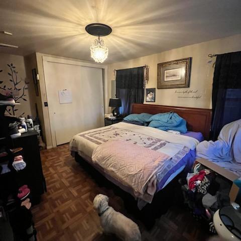 bedroom featuring a closet and an inviting chandelier