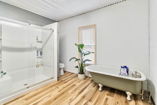 bathroom featuring hardwood / wood-style floors, toilet, and independent shower and bath