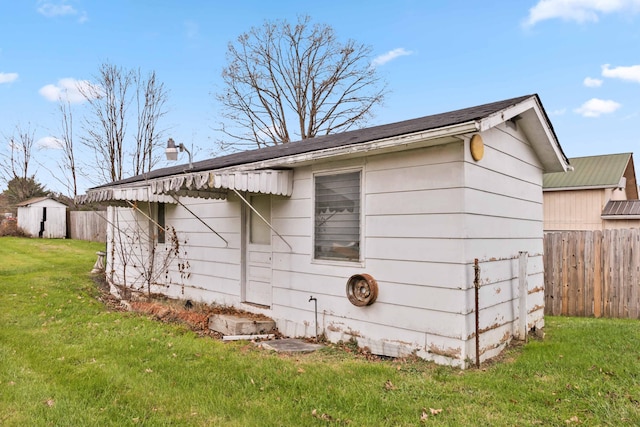 view of side of home with a yard