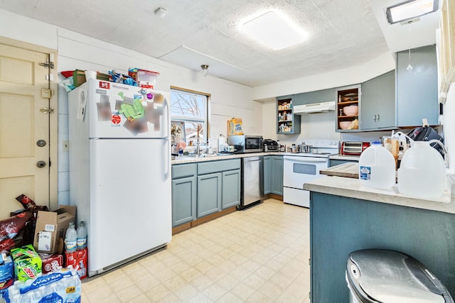 kitchen with sink, extractor fan, a textured ceiling, and appliances with stainless steel finishes