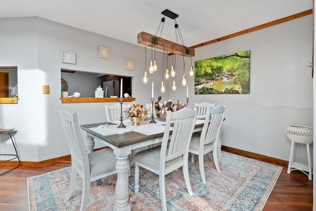 dining area with an inviting chandelier and dark wood-type flooring