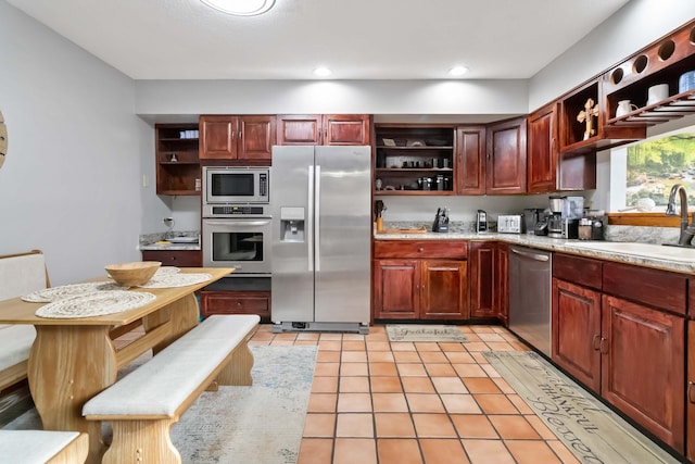 kitchen featuring sink, light tile patterned floors, and stainless steel appliances