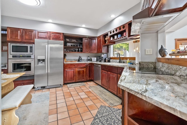 kitchen with light stone countertops, appliances with stainless steel finishes, sink, light tile patterned floors, and hanging light fixtures