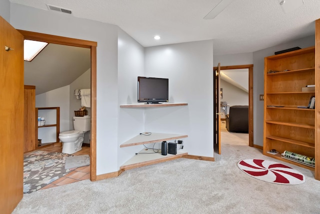 carpeted living room featuring a textured ceiling