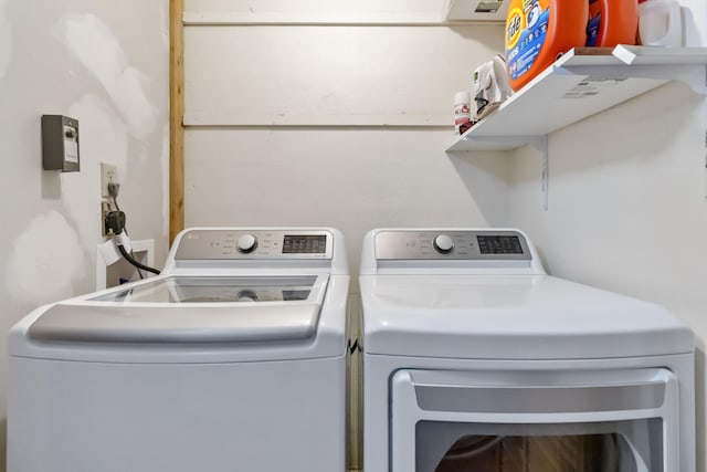 clothes washing area featuring washer and clothes dryer