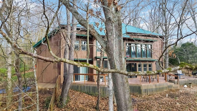 back of property with a wooden deck