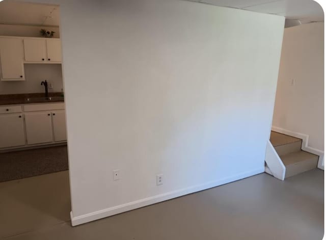 interior space featuring a sink and baseboards