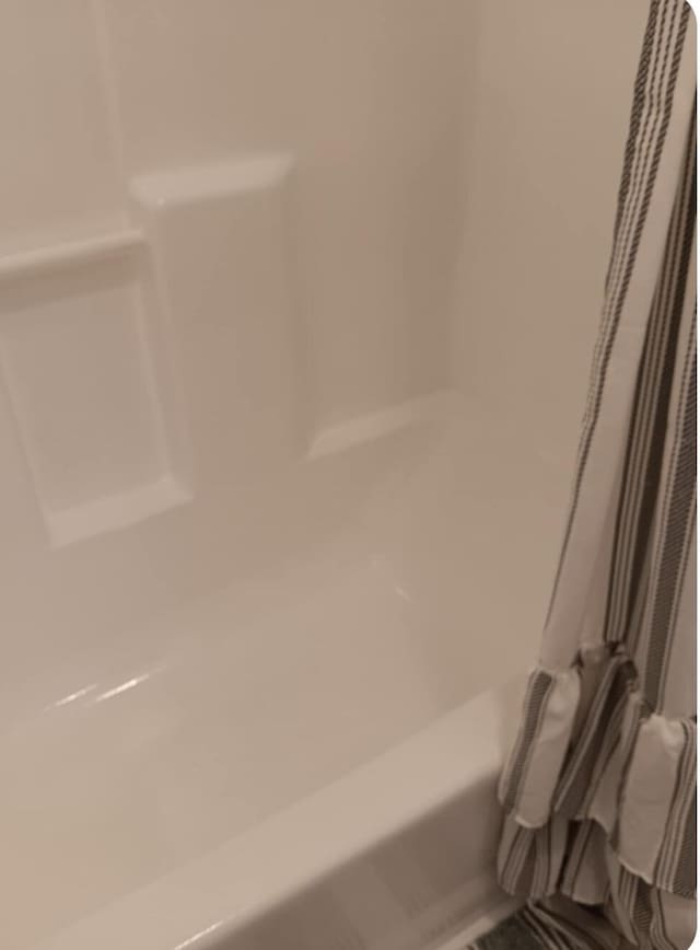 details with a bathing tub and walk in shower