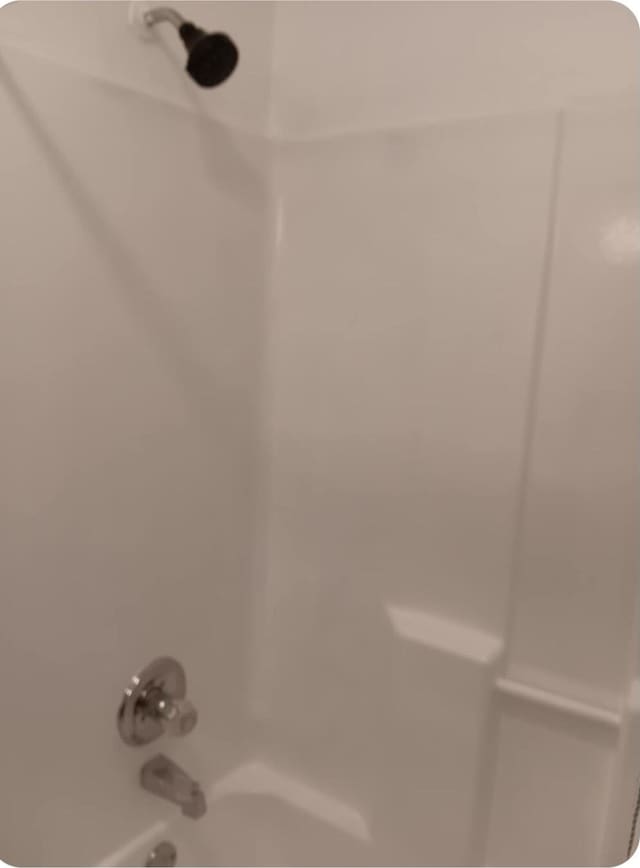 room details featuring bathing tub / shower combination