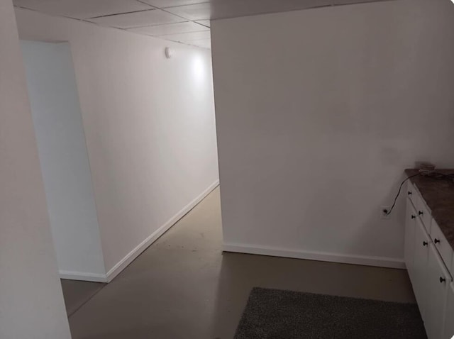 interior space with baseboards and concrete flooring