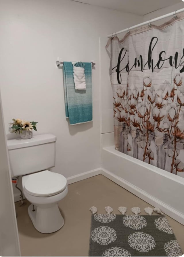 bathroom with shower / tub combo and toilet