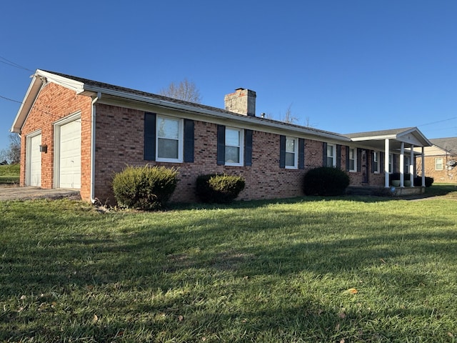 view of side of home featuring a yard and a garage