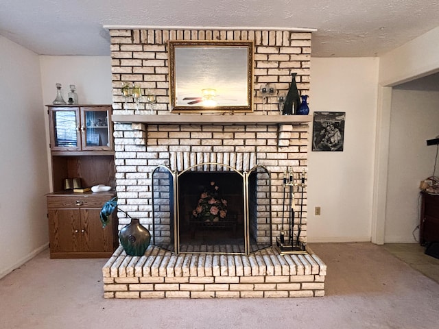 room details featuring carpet flooring, a fireplace, and a textured ceiling