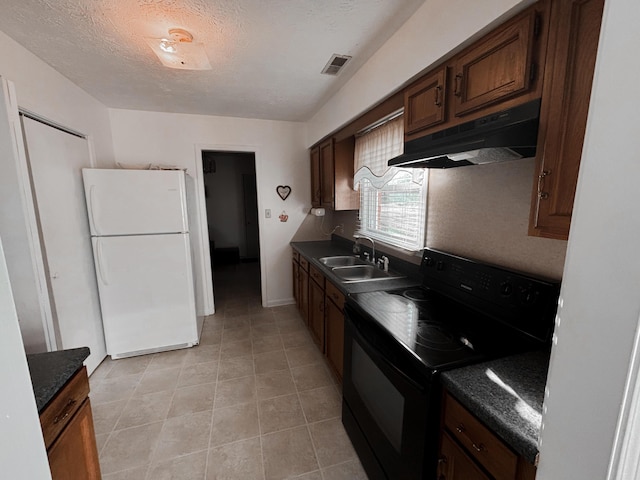 kitchen with black range with electric stovetop, sink, white fridge, a textured ceiling, and light tile patterned flooring