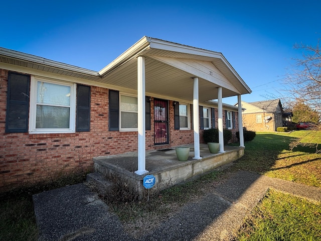 view of front of house with a porch and a front yard