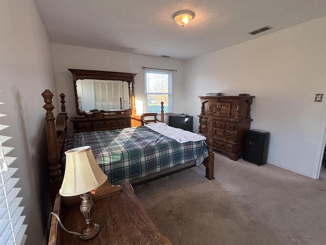 bedroom featuring carpet and a textured ceiling