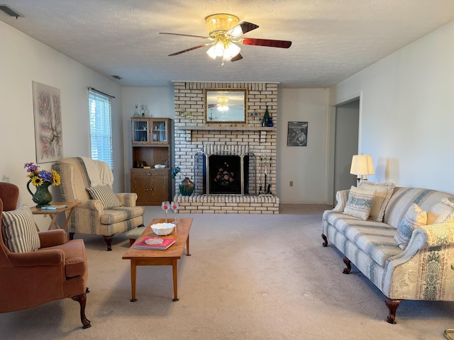 carpeted living room featuring ceiling fan, a textured ceiling, and a brick fireplace