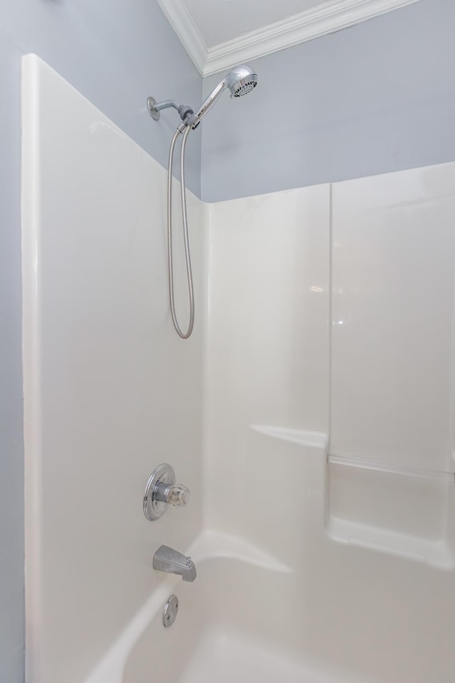 bathroom with shower / bathtub combination and crown molding