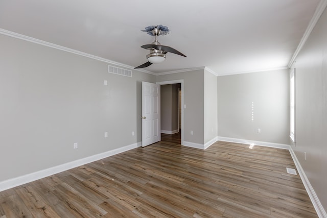 empty room with ceiling fan, visible vents, baseboards, light wood-style floors, and crown molding