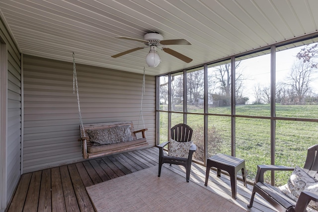 unfurnished sunroom featuring ceiling fan