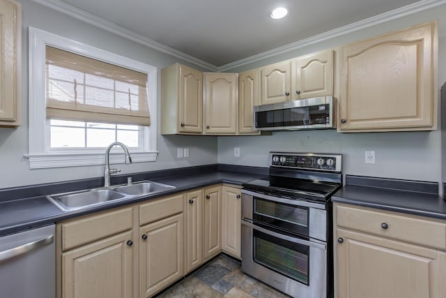 kitchen featuring appliances with stainless steel finishes, dark countertops, a sink, and ornamental molding