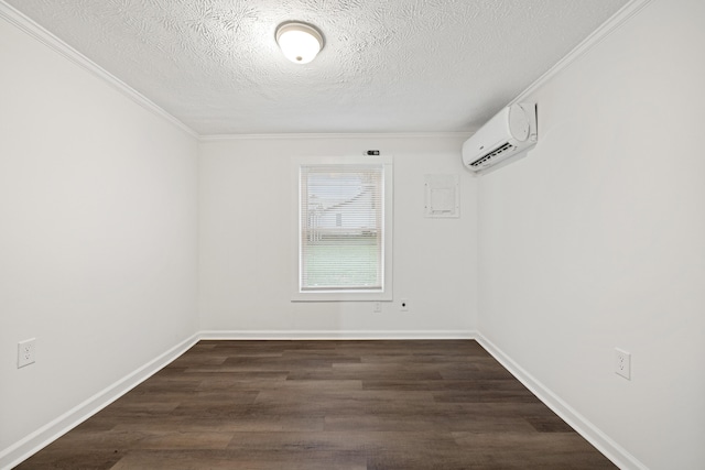 unfurnished room with a textured ceiling, dark hardwood / wood-style floors, a wall unit AC, and crown molding
