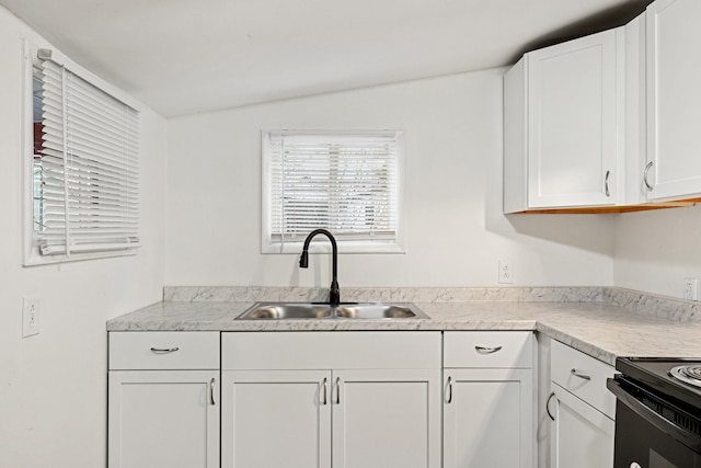 kitchen featuring electric stove, white cabinetry, sink, and lofted ceiling