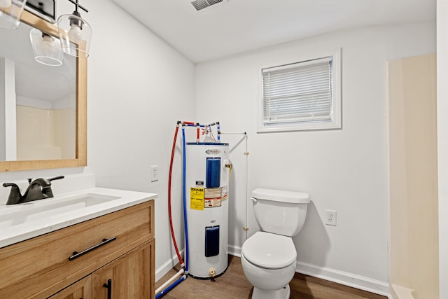 bathroom with hardwood / wood-style floors, vanity, toilet, and water heater