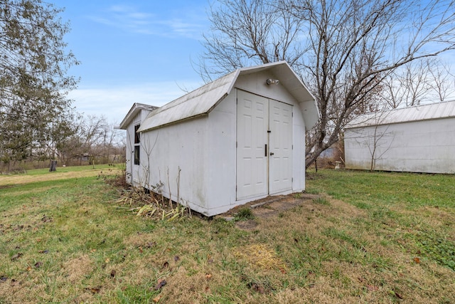 view of outdoor structure featuring a lawn