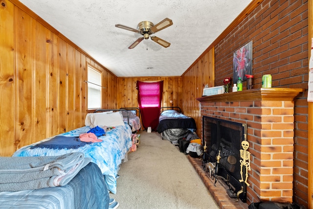 bedroom featuring ceiling fan, a textured ceiling, ornamental molding, and carpet flooring