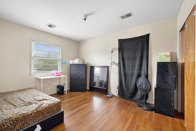 bedroom featuring wood-type flooring and a closet