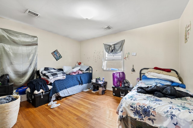 bedroom with hardwood / wood-style floors