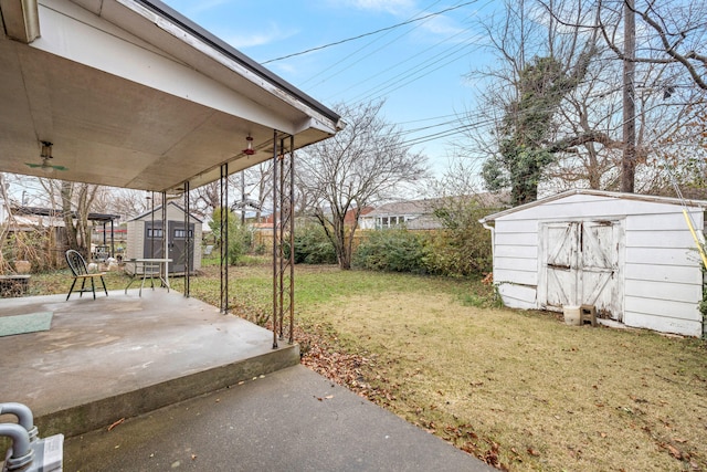 view of yard with a storage unit and a patio