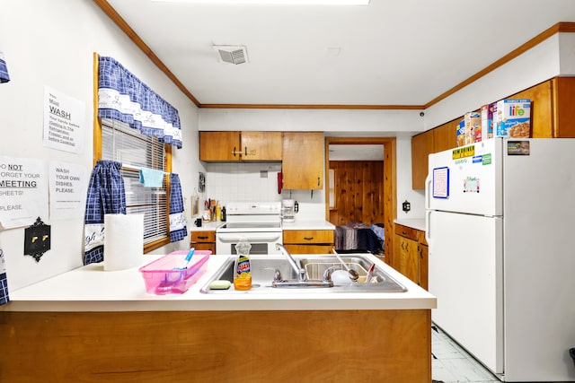 kitchen featuring white appliances, sink, backsplash, ornamental molding, and kitchen peninsula