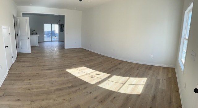 spare room with light hardwood / wood-style floors and sink