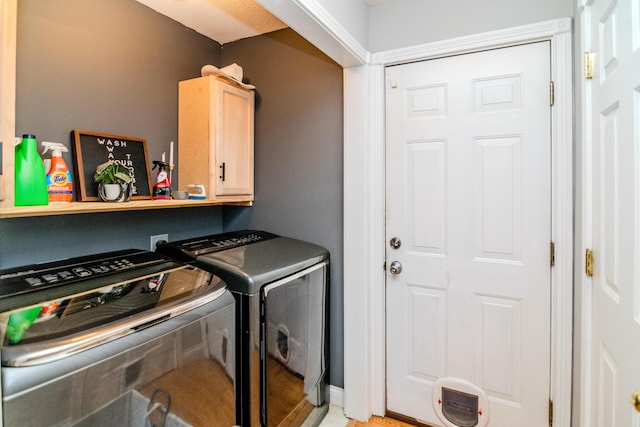 laundry area with cabinet space and washer and clothes dryer