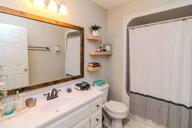 bathroom with toilet, vanity, and a shower with curtain