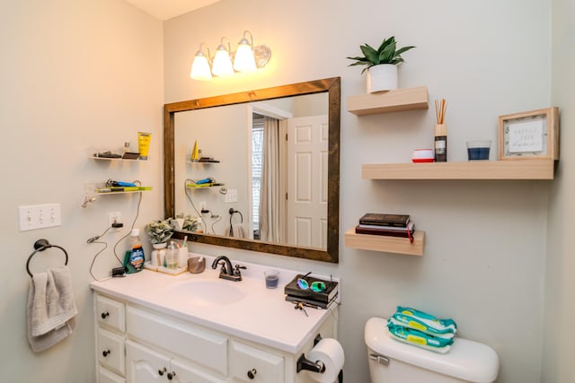 bathroom featuring toilet and vanity