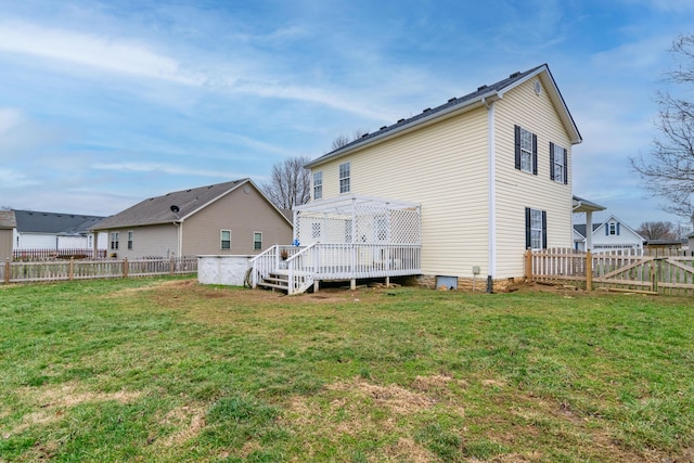 back of property featuring a yard, a fenced backyard, and a wooden deck