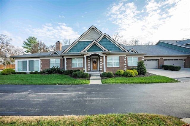 view of front of house with a front yard and a garage