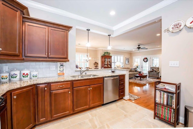 kitchen featuring stainless steel dishwasher, ceiling fan with notable chandelier, a healthy amount of sunlight, and sink