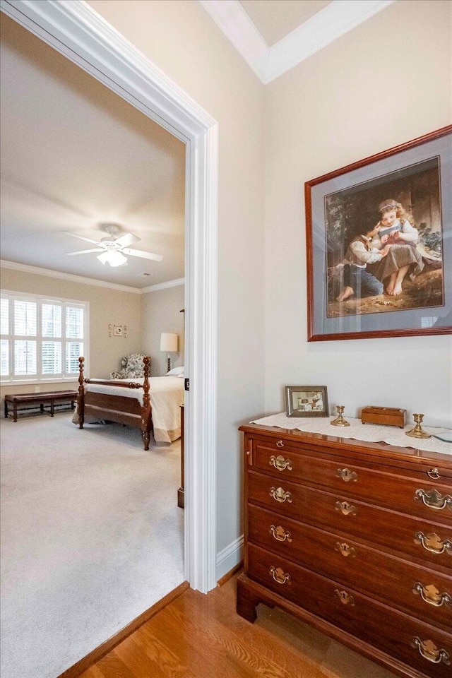 bedroom with hardwood / wood-style flooring, ceiling fan, and crown molding