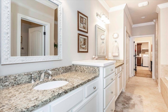 bathroom with tile patterned flooring, vanity, ornamental molding, and independent washer and dryer