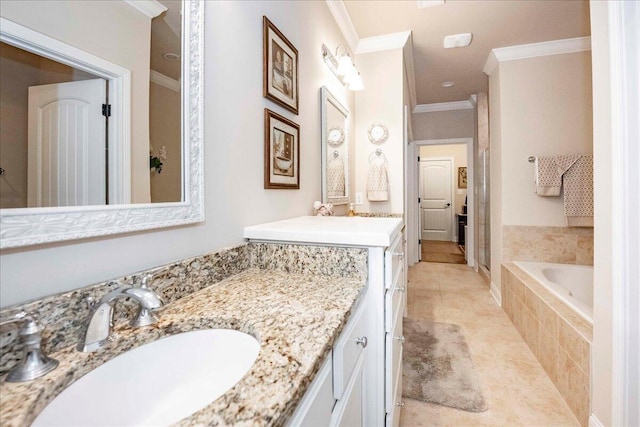 bathroom with tile patterned flooring, vanity, tiled bath, and ornamental molding