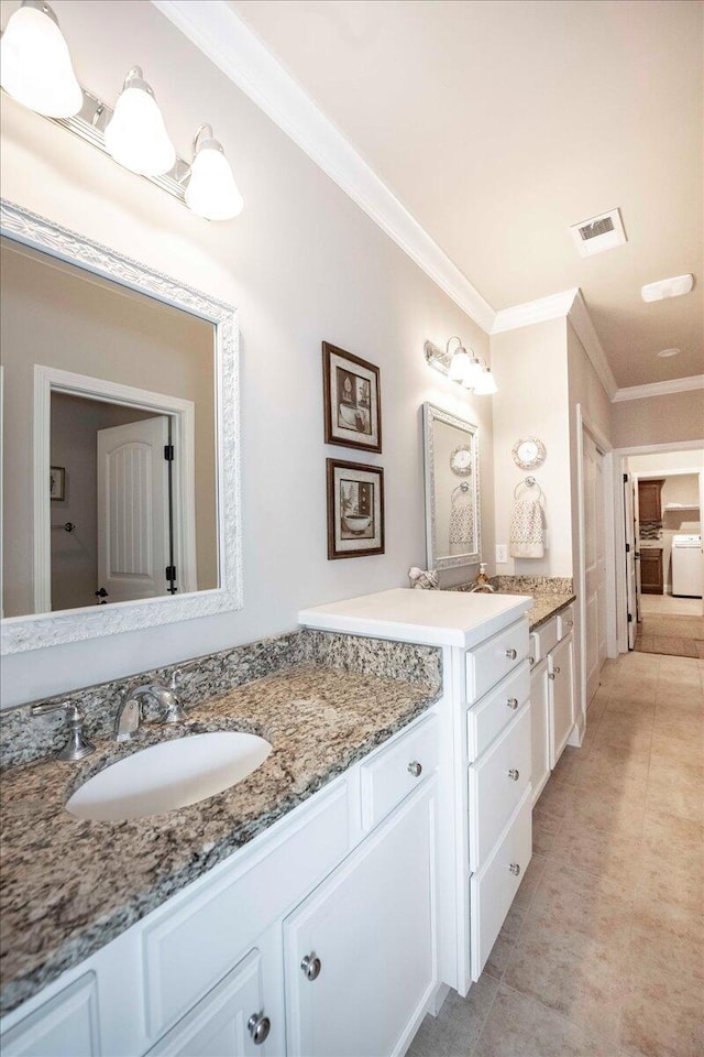 bathroom featuring vanity, tile patterned floors, washer and clothes dryer, and crown molding