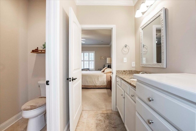 bathroom featuring tile patterned flooring, vanity, toilet, and ornamental molding