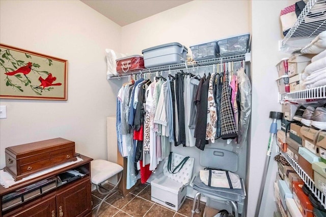 walk in closet featuring dark tile patterned floors