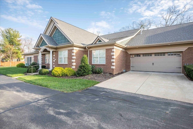 view of front of property featuring a front yard and a garage