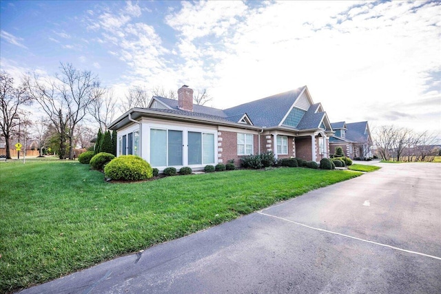 view of home's exterior with a yard