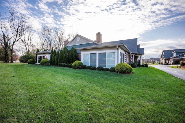 view of property exterior with a yard